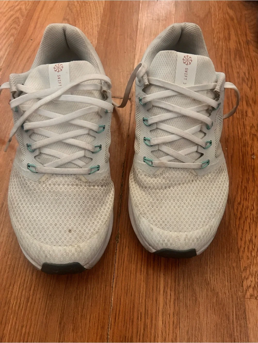Nike Women's White Sneakers with Coral Swoosh and Teal Accents